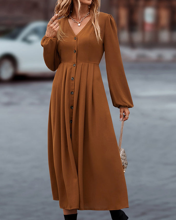 Elegante midi-jurk met knoopsluiting en lange ballonmouwen, ideaal voor een stijlvolle kijk