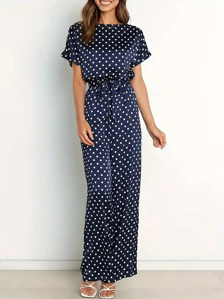 Elegante dames jumpsuit met speelse stippen en stijlvolle afwerking