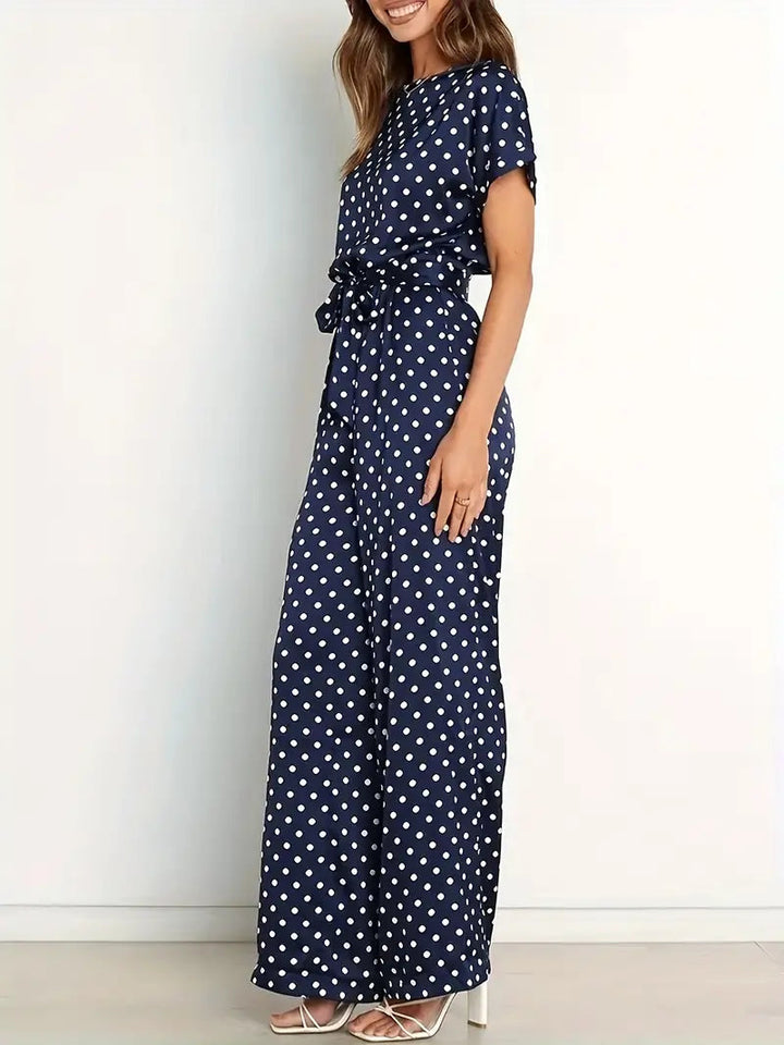 Elegante dames jumpsuit met speelse stippen en stijlvolle afwerking