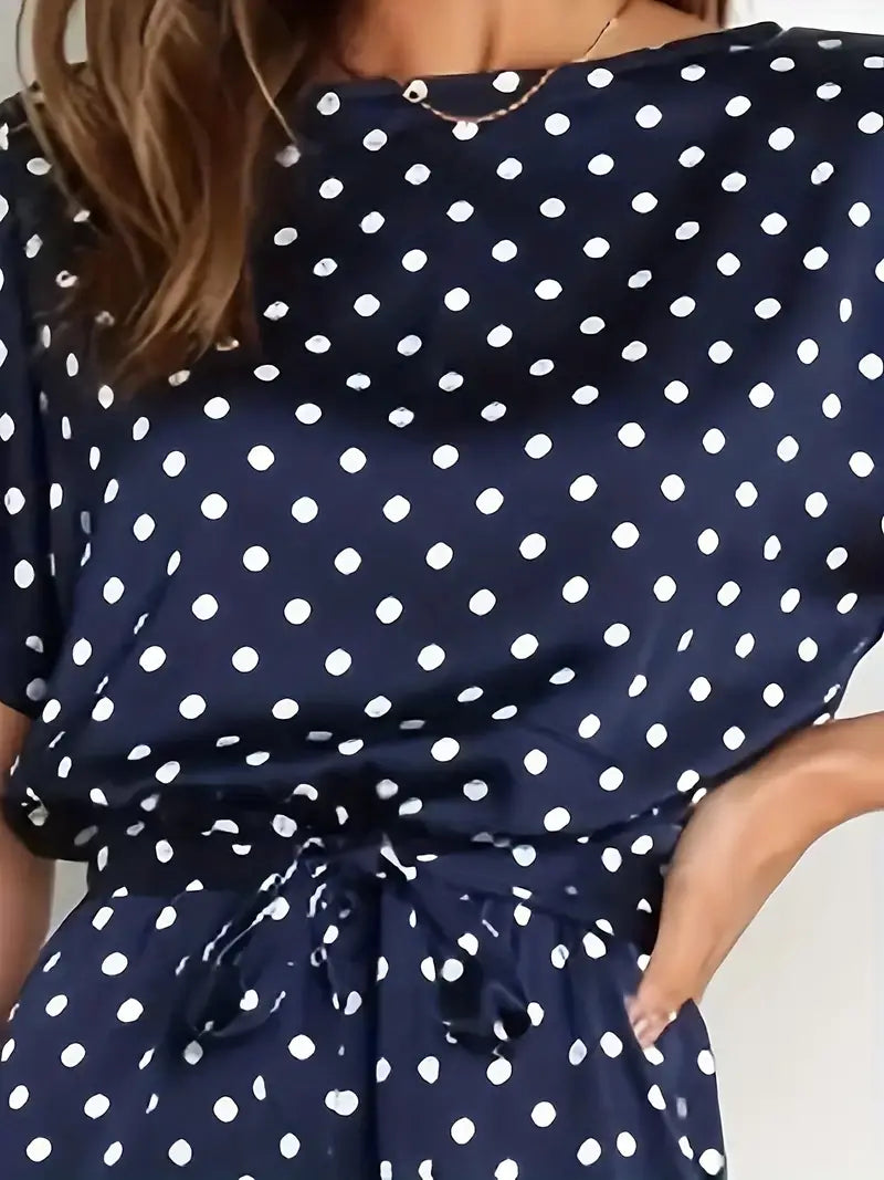 Elegante dames jumpsuit met speelse stippen en stijlvolle afwerking