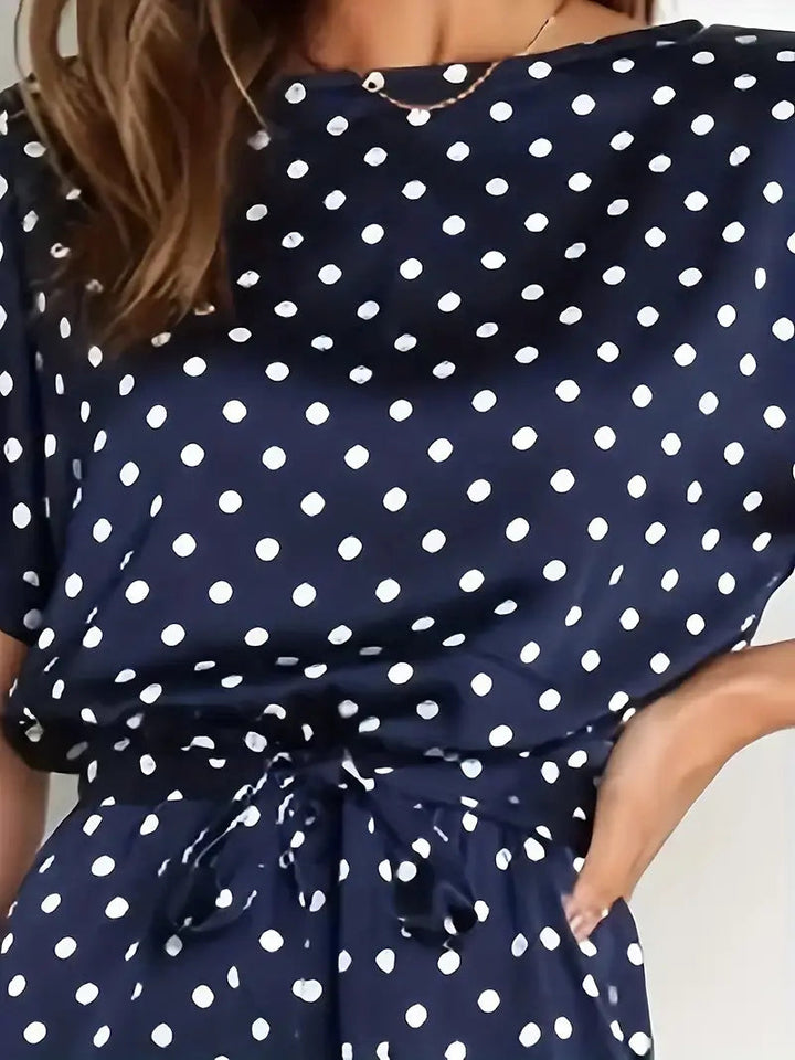 Elegante dames jumpsuit met speelse stippen en stijlvolle afwerking