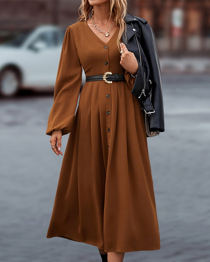 Elegante midi-jurk met knoopsluiting en lange ballonmouwen, ideaal voor een stijlvolle kijk