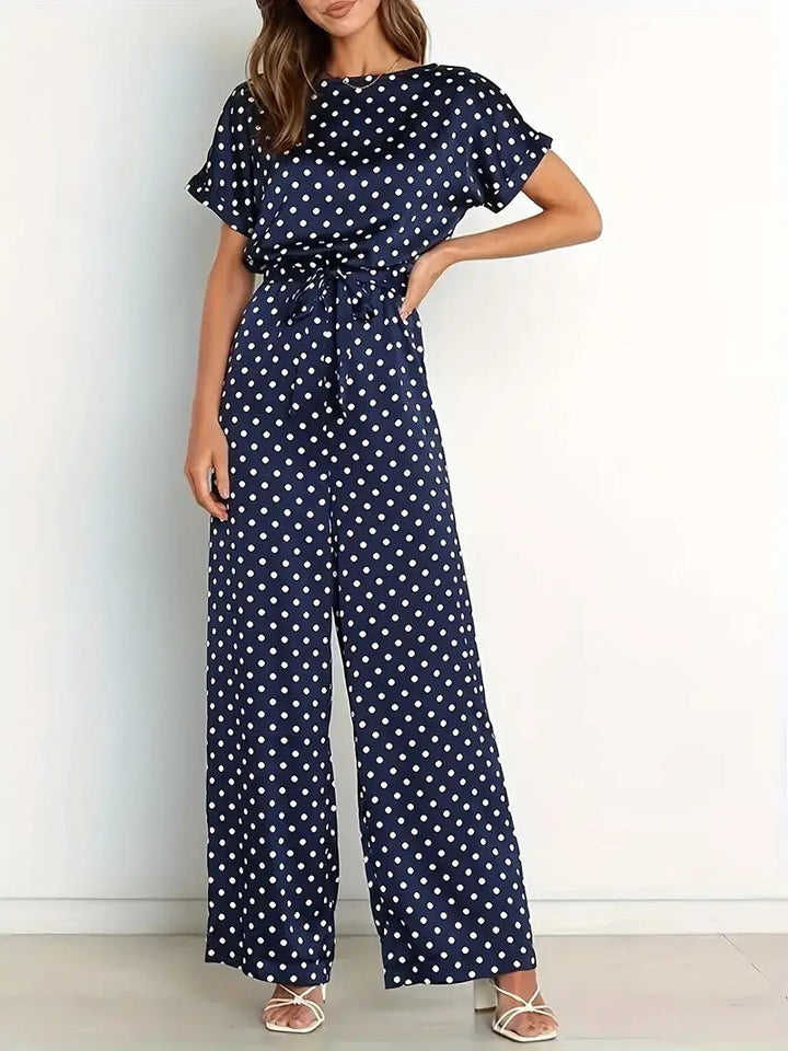Elegante dames jumpsuit met speelse stippen en stijlvolle afwerking