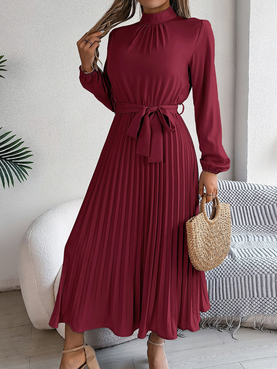 Elegante damesjurk met opstaande kraag lange mouwen en geplooide rok