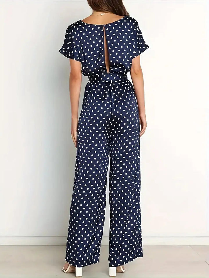 Elegante dames jumpsuit met speelse stippen en stijlvolle afwerking