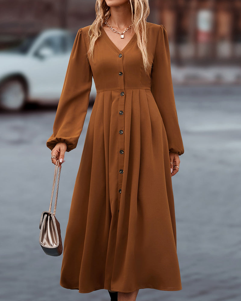Elegante midi-jurk met knoopsluiting en lange ballonmouwen, ideaal voor een stijlvolle kijk